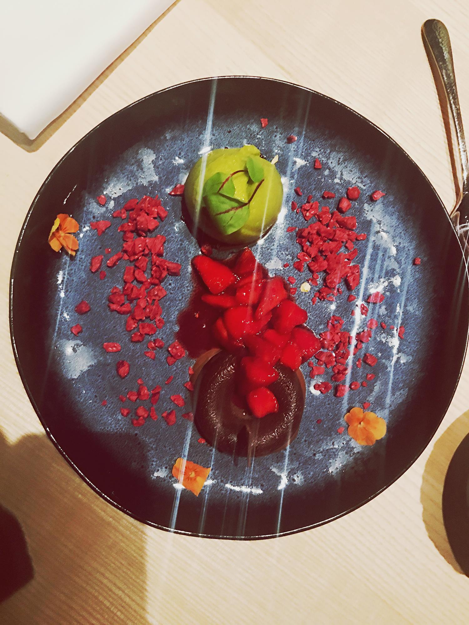 Chef arranging a colorful plate in a cozy kitchen